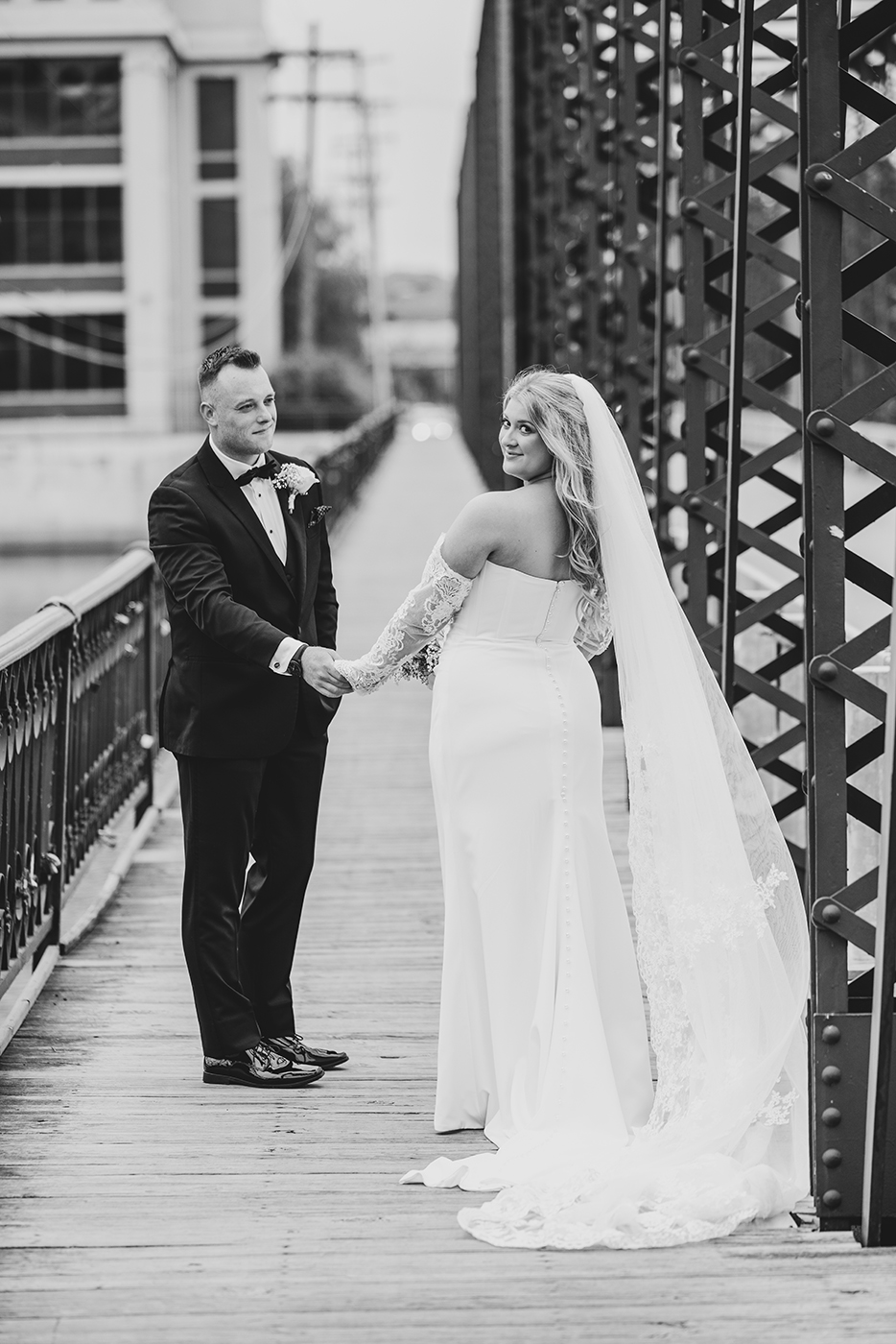Couple walking on the 6th bridge in grand rapids